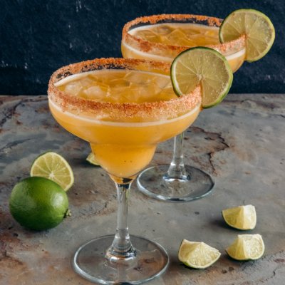 Delicious smoky and spicy margaritas with lime and fresh fruit juice