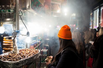 Enjoying roasted chestnuts at a winter street festival