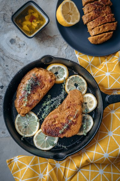 Vegan chicken in skillet with lemon and thyme