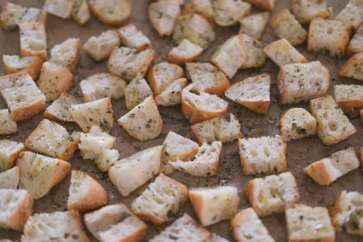 season the cubed bread with olive oil and herbs, garlic salt and pepper