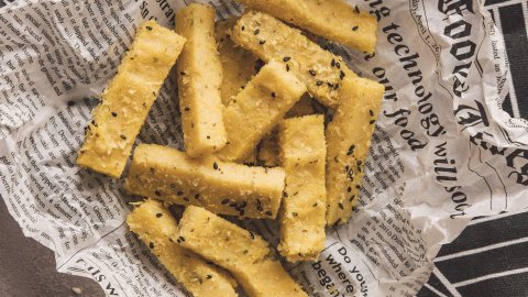 Delicious and fresh polenta chips served on retro newspaper like paper
