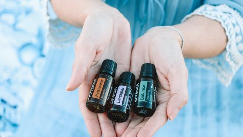 Woman holding essential oils in her hands